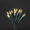 A bunch of yellow LED string lights tied together against a black background. Produktbild-Vorschau