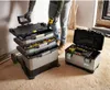 A person is using a rolling tool chest in what appears to be a construction or workshop environment. Voir les images du produit