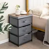 A bedside table with fabric drawers next to a bed. Podgląd zdjęcia produktu