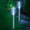 Two solar-powered garden lights with bubble effects are illuminated in a garden at dusk. Produktbild-Vorschau