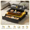 A modern coffee table with multiple storage compartments and LED lighting, shown in an open state to display its features. Produktbild-Vorschau