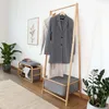 A hallway or entryway with a coat rack, shoe bench, and plants. Anteprima dell’immagine prodotto