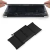 A laptop battery is shown next to a disassembled laptop. Produktbild-Vorschau