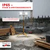 A construction site in the rain with a portable LED work light. Produktbild-Vorschau