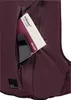 A close-up view of a dark purple backpack pocket with a phone and a city guide book inside. Produktbild-Vorschau