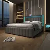 A modern bedroom with a bed, nightstand, and window overlooking a city at night. Náhled obrázku produktu