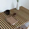 A corner of a desk with a mug, a notebook, and a vase. Podgląd zdjęcia produktu