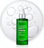 A green bottle of Vichy Dercos anti-dandruff serum is shown against a clear background with water bubbles. Podgląd zdjęcia produktu