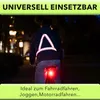 A person riding a bicycle at night wearing a reflective vest. Náhľad obrázku produktu