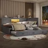 A bedroom scene featuring a gray wooden bed with a pull-out trundle bed and integrated LED lighting. Podgląd zdjęcia produktu