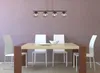 A dining table with chairs and a pendant light fixture. Anteprima dell’immagine prodotto