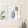 A white wall with a mirror, a hat rack with hats, and an umbrella stand with umbrellas. Náhľad obrázku produktu