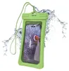 A green waterproof phone case with a smartphone inside displaying a clownfish, surrounded by splashing water. Produktbild-Vorschau