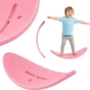 A child is balancing on a pink balance board, with close-up views of the board. Podgląd zdjęcia produktu