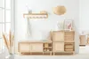 A bright, minimalist entryway with a wooden shoe bench and storage unit. Produktbild-Vorschau