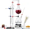 A laboratory distillation setup for essential oils, including glassware, a heating plate, and accessories, displayed on a white background. Produktbild-Vorschau