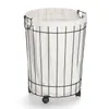 A laundry basket with a canvas liner and a metal frame, shown on a white background. Náhled obrázku produktu