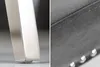 Close-up shots of a chair's metal leg and upholstered fabric with decorative studs. Produktbild-Vorschau