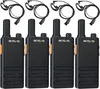 Four black walkie-talkies with orange accents and attached earpieces are arranged in two rows on a white background. Produktbild-Vorschau