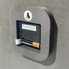 The back of a wall clock showing the battery compartment and mounting mechanism. Produktbild-Vorschau