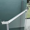 A close-up view of a modern shower enclosure, showing the metallic handle and glass panels. Produktbild-Vorschau