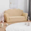 A cream-colored children's sofa is shown in a room with a white rug and wooden floor. Voir les images du produit