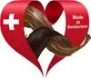 A red ribbon in the shape of a heart with a Swiss cross and text "Made in Switzerland" on it, with flowing chocolate inside. Produktbild-Vorschau