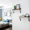 A bedroom scene with a bed, desk, and wall shelves. Produktbild-Vorschau