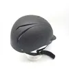 A black riding helmet on a white stand against a white background. Produktbild-Vorschau