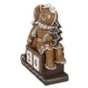 A decorative Christmas advent calendar figurine shaped like gingerbread people sitting on a sleigh with blocks showing the date 24. Produktbild-Vorschau