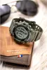A watch and wallet are placed on a fluffy white surface, with sunglasses in the background. Voir les images du produit