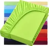 A stack of colorful fitted sheets, with the top one in lime green prominently displayed. Produktbild-Vorschau