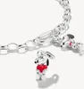 A close-up shot of a silver charm bracelet with two Snoopy charms, one holding a red heart. Podgląd zdjęcia produktu
