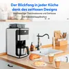 A coffee machine is shown on a kitchen counter next to a sink and some pastries. Produktbild-Vorschau