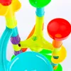 A close-up view of a colorful children's toy, likely a marble run or water play set, with various interconnected plastic pieces. Produktbild-Vorschau
