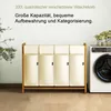 A laundry basket with four compartments next to a washing machine. Anteprima dell’immagine prodotto