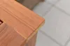 A close-up view of the corner of a wooden table or furniture piece. Náhled obrázku produktu