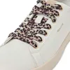 A close-up shot of the front of a white sneaker with leopard print laces. Voir les images du produit