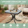 A square glass-top side table with a black metal base is shown on a patio with plants and a blanket draped over a sofa in the background. Icons and text suggest its uses. Podgląd zdjęcia produktu