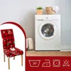 A Christmas-themed chair cover is shown in a close-up view, with a washing machine and laundry basket in the background. Care symbols are displayed at the bottom. Náhled obrázku produktu
