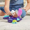 A child is playing with a toy airplane on a carpeted floor. Podgląd zdjęcia produktu