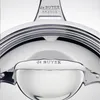 A close-up view of a shiny metal pan, showing the brand name "de BUYER" embossed on the handle and on the upper part of the pan. Anteprima dell’immagine prodotto