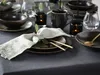 A table setting with plates, cutlery, napkins, and candles. Produktbild-Vorschau