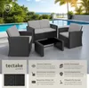 A rattan lounge set with cushions and a coffee table is displayed on a patio by a swimming pool with a view of the ocean. Produktbild-Vorschau