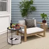 An outdoor patio scene with a side table, chair, and plants. Produktbild-Vorschau