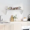 A kitchen shelf with items on it, above a countertop with a sink and cabinets. Produktbild-Vorschau