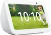 A smart display showing the time and weather, with a dog running in a grassy field. Produktbild-Vorschau