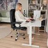 A woman working at a desk in a home office setting. Produktbild-Vorschau