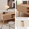 A collage of images showing a wooden TV stand with a robot vacuum cleaner underneath, and close-ups of its design features. Produktbild-Vorschau