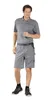 A man is standing and posing for a product photo, wearing work shorts and a polo shirt. Produktbild-Vorschau